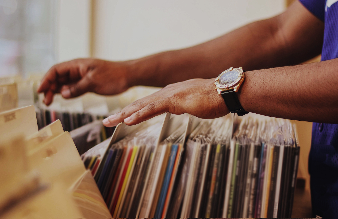 Person going through vinyls in-store