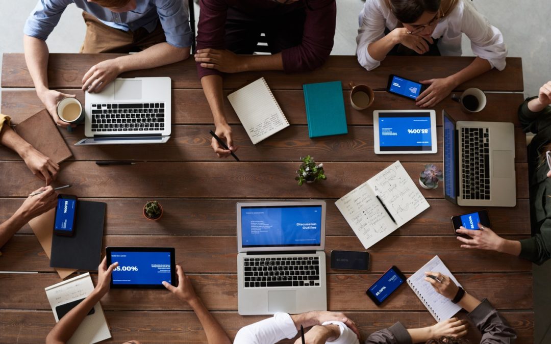 People meeting at table to discuss music strategy